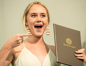 Happy graduate with diploma. Link to Gifts of Cash, Checks, and Credit Cards